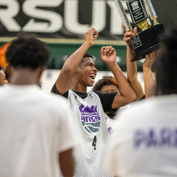 KQR youth celebrating as a championship trophy is lifted up